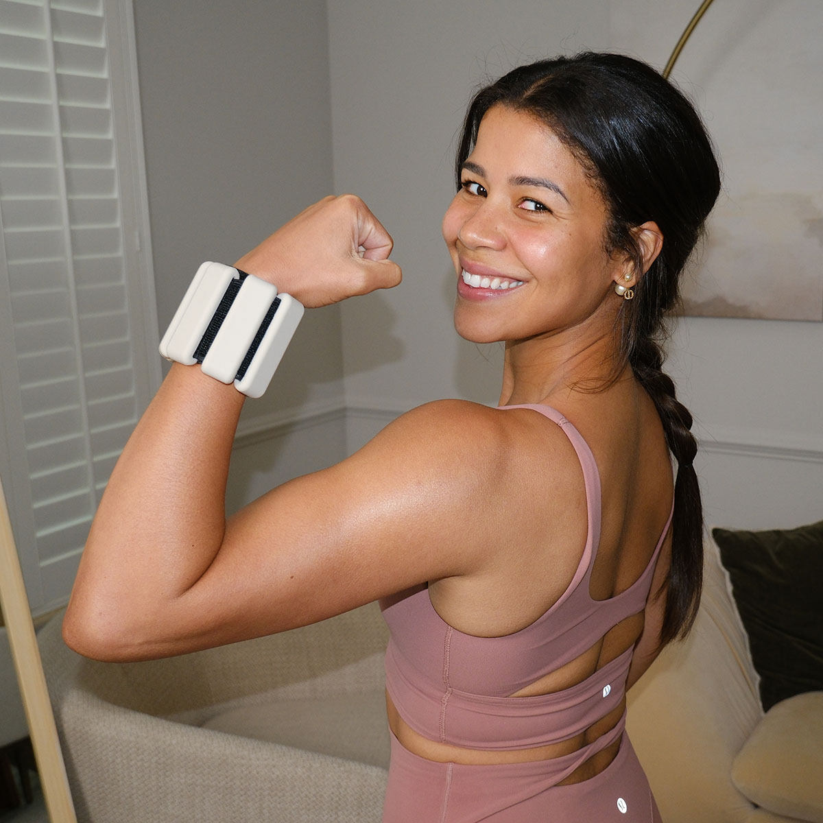 Jo, smiling and flexing in workout gear